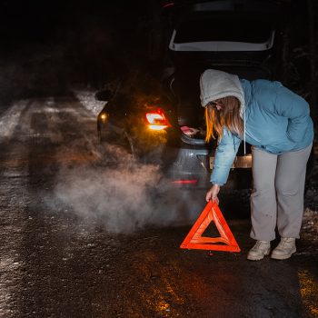 A dark road at night representing a missed opportunity to help a stranded driver.